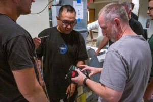 Students making adjustments to the equipment system.