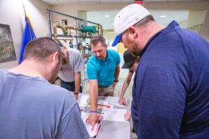 Instructor explaining diagrams to students.