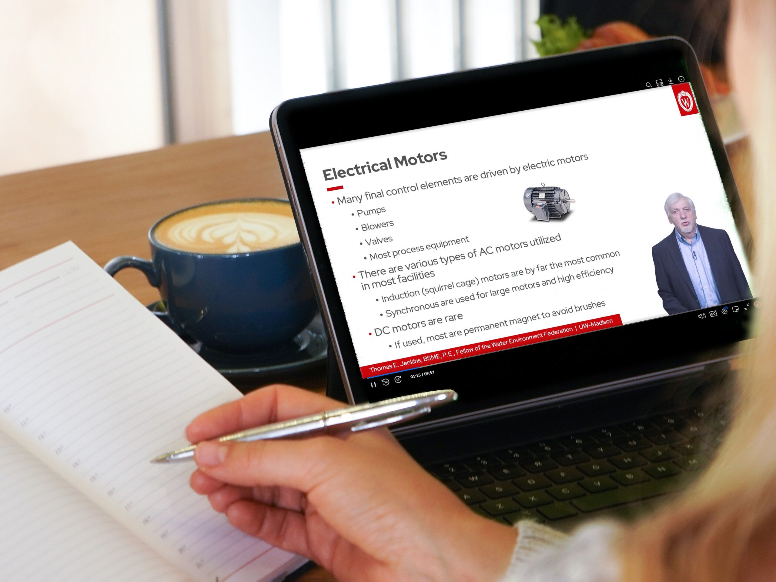 Student attending an online lecture on electric motors and taking notes